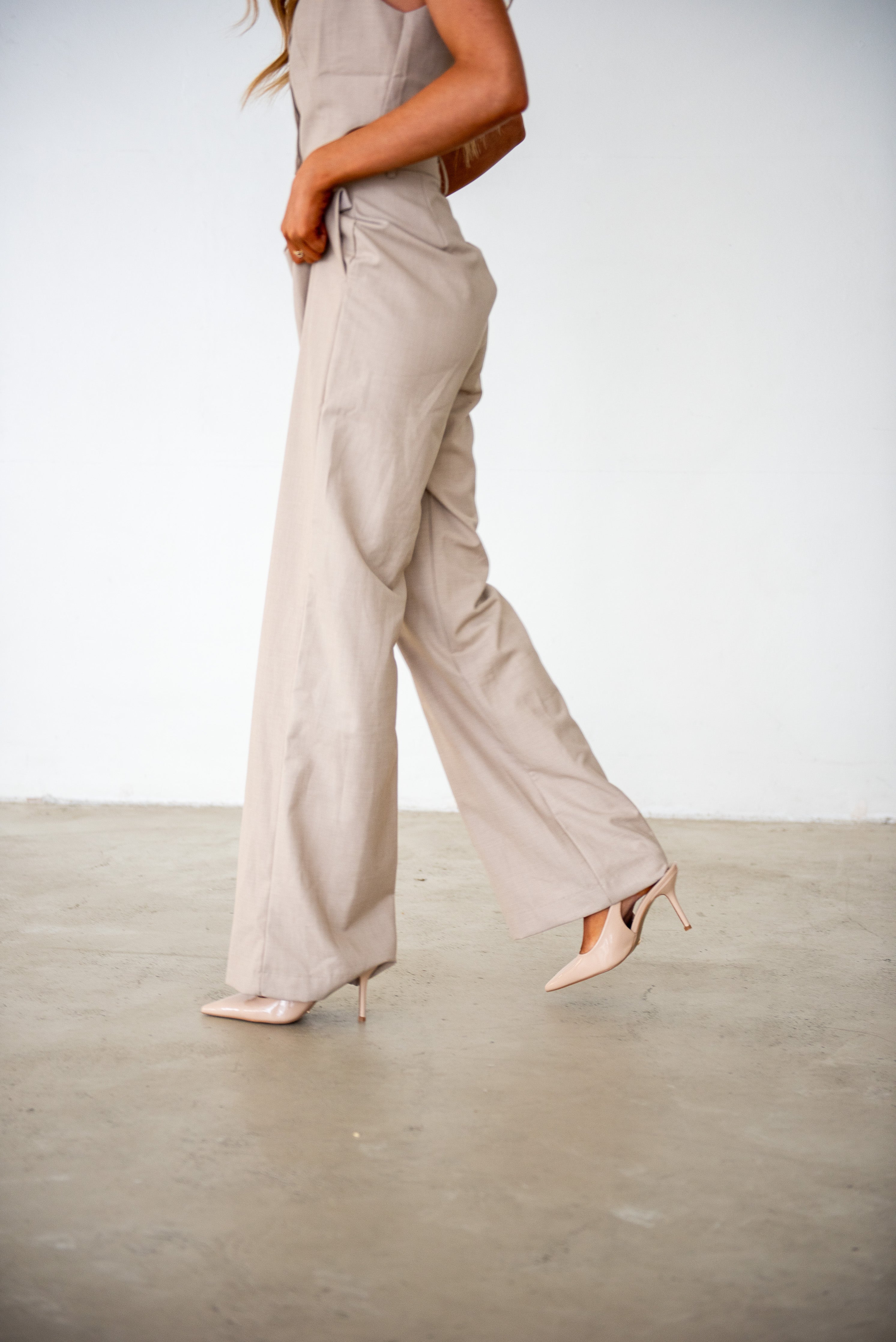 Close-up of a professional outfit with tailored beige trousers and nude heels, showcasing the stylish and modern aesthetic of the Lash and Brow Training Academy at By Tarnee Morris in Penrith.