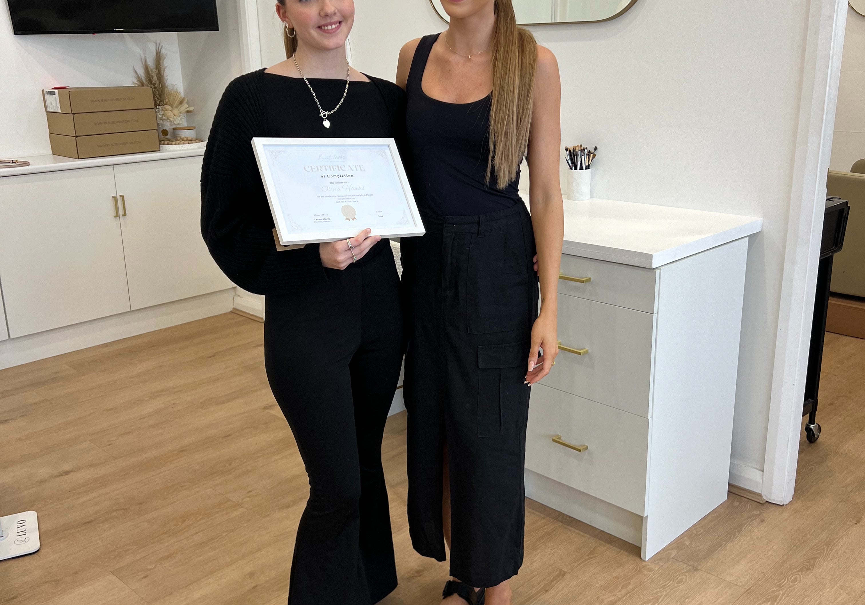 Graduate proudly holding her certificate with a Certified Lash Educator at By Tarnee Morris in Penrith, celebrating completion of a professional lash and brow course
